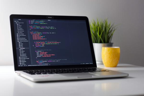 Laptop showing lines of code on screen